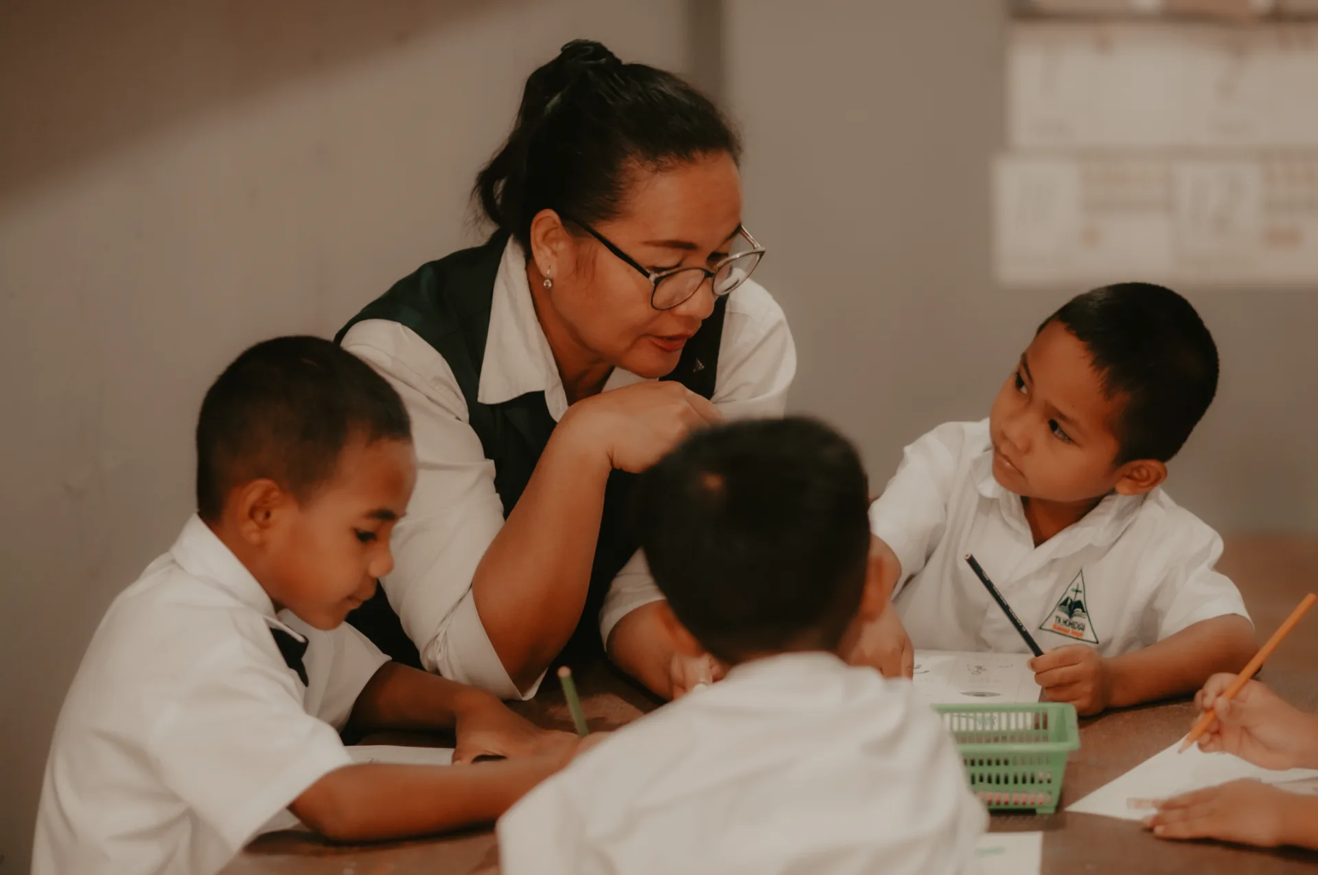 Teacher guiding students in a Rahai classroom